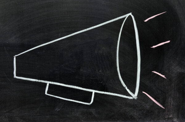 A chalkboard with a magaphone drawn on it.