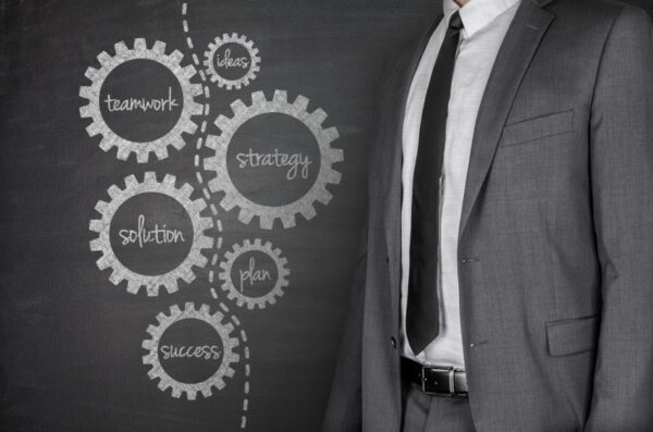 A Chalkboard with a cluster of gear-shaped circles drawn to symbolize working components of psychiatric diagnostic and treatment assessment.